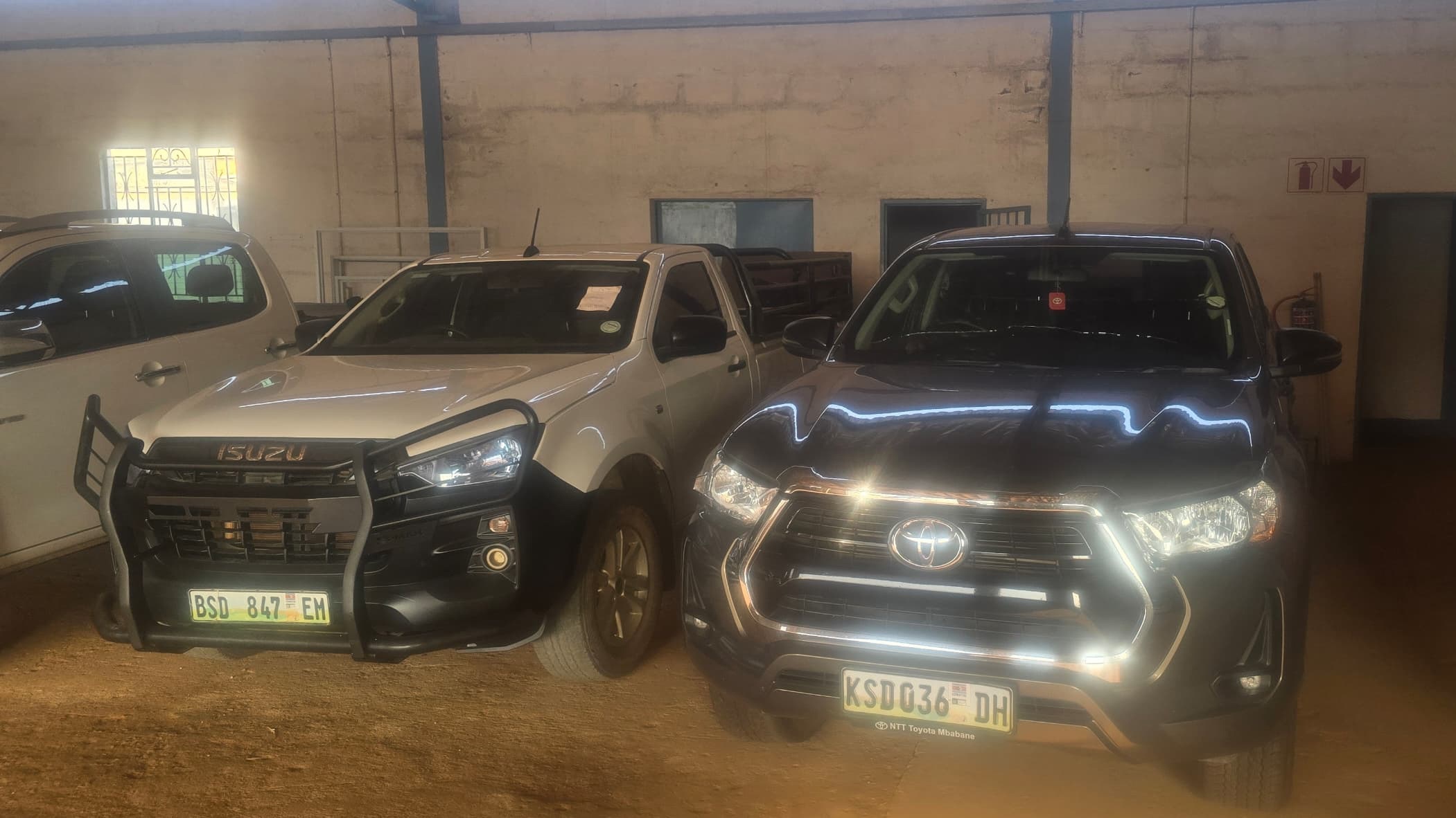 This Isuzu and Toyota Hilux are part of the items to be auctioned.